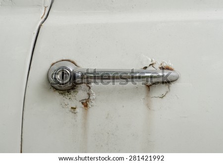 Chrome door handle of old white car