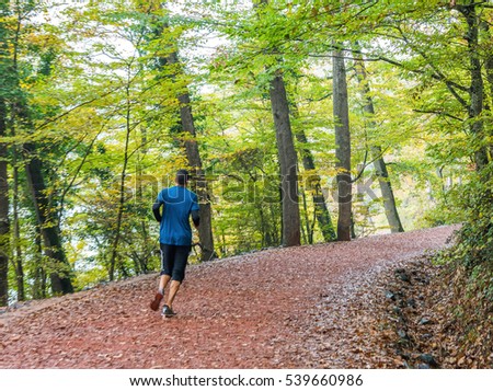 Young man running on forest