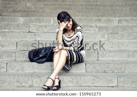 Fashion style portrait of beautiful young woman wearing elegant stylish clothing, pencil skirt, black boots and scarf.