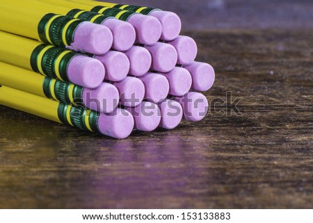 A bundled set of pencils close-up showing the erasers.