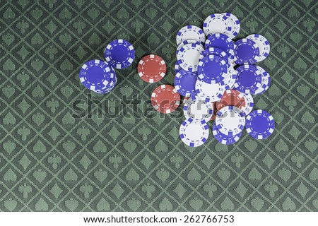 casino background poker chips sitting on green poker felt with room for text