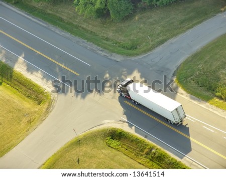 Aerial view of a truck approaching a roads intersection.
