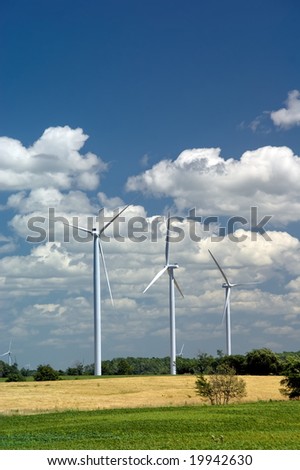 Power Generating Windmills on green field. Alternative energy source. Ontario, Canada
