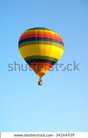 Colored Hot Air Balloon on solid blue sky background