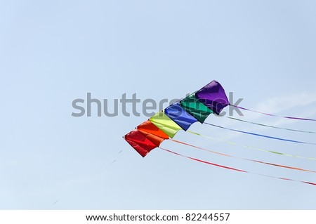 Colorful kite soaring against blue sky. Summer Kite Festival