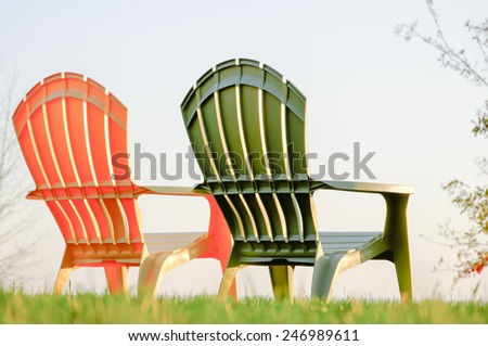 Two lawn chairs on a green grass