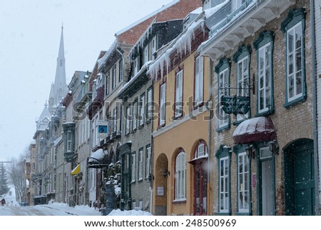Quebec-city, Canada - December 26, 2013. Houses on historical street covered by snow in blizzard. Winter in Old Quebec city, Canada.