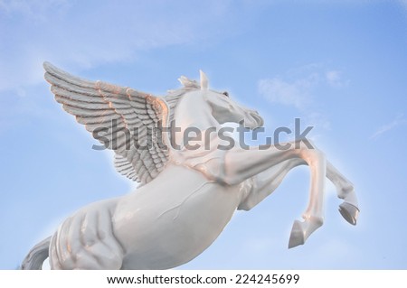 The flying horse statue on the sky with clouds.