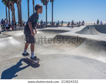 LOS ANGELES, CALIFORNIA - JULY 23: Skateboarder at skateboard park on beach on July 23, 2014 in Venice Beach, Los Angeles, California, USA
