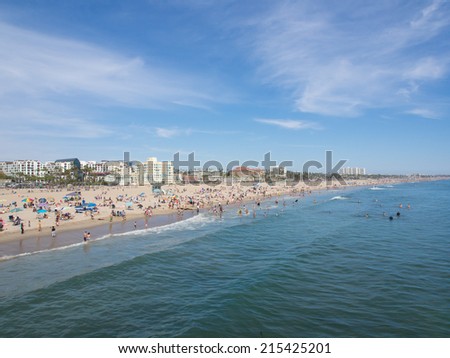 LOS ANGELES, USA - MAY 4: Many people sunbathe on the sand beach and swim in the ocean on May 4, 2014 in Santa Monica Beach, Los Angeles, CA, USA