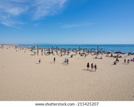 LOS ANGELES, USA - MAY 4: Many people sunbathe on the sand beach and swim in the ocean on May 4, 2014 in Santa Monica Beach, Los Angeles, CA, USA