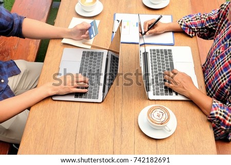 Working together with laptop with  coffee cup on table, Hand typing on laptop keyboard with coffee , using computer with hand typing on keyboard