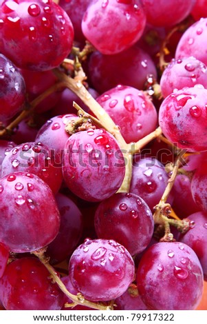 Image of red grape background with water drops