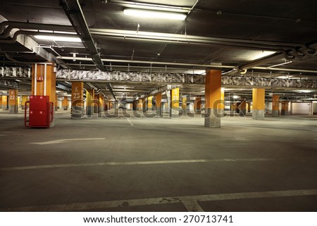 Image of parking garage underground interior, dark industrial building, modern public construction