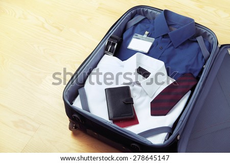 Image of businessman\'s clothes in travel bag