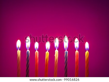 Image of eight birthday candles over purple background