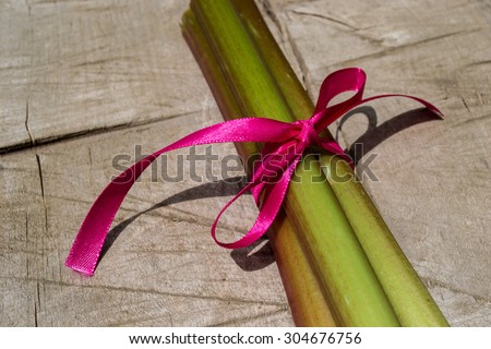 Rhubarb, rhubarb tied with a ribbon, vegetables, stem plants, healthy, compote of rhubarb pie, syrup, rhubarb, green, red, dessert, vegetarian, grows in the garden