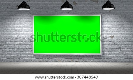 old brick wall and green screen picture frame illuminated with spotlights