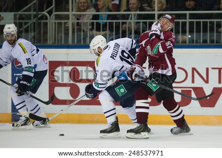 RIGA, LATVIA - JANUARY 30: Gints Meija (87) reacts as Pascal Pelletier (19) hits him in the face in KHL game between Dinamo Riga and Medvescak Zagreb played on JANUARY 30, 2015 in Arena Riga