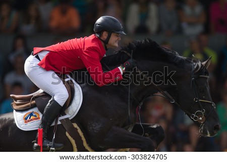 RIGA, LATVIA - Aug 2: Rider Oliver KARMA (EST) with horse VANCO Z (55)  jumps over the obstacle at FEI World Cup Qualifying competition CSI2*-W on August 2, 2015 in Riga