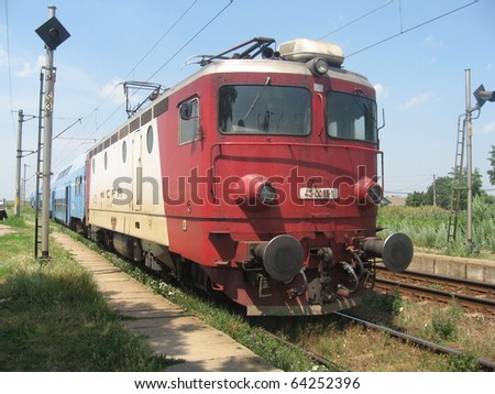 Daily commuter train is stopping in a Moldavian city tracked by a Serbian locomotive