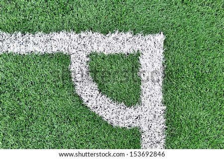 White stripe corner on the green soccer field from top view