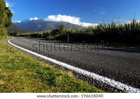 Beautiful asphalt highway curve road to the mountain in summer New Zealand