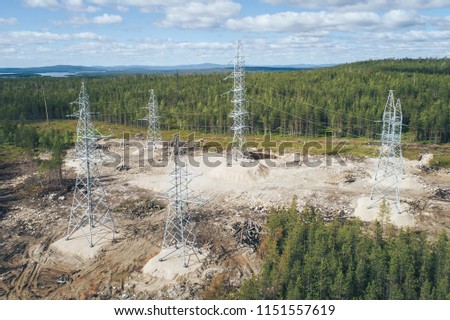 High Voltage Power Lines Electricity Pylons Towers Supplying Aluminum Plant. Aerial View