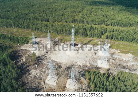 High Voltage Power Lines Electricity Pylons Towers Supplying Aluminum Plant. Aerial View