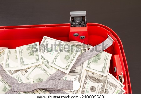 Lots of dollars with an open copybook
