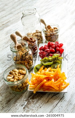Selection of dried fruits in jars and on a plate