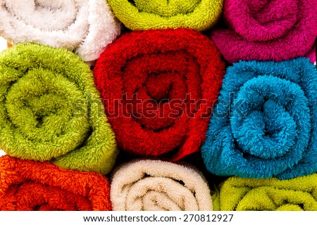 Group of colorful towels rolled up, background