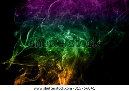 Abstract colorful smoke on black background, color background,colorful ink background,Violet and Green and Orange smoke,Movement of smoke