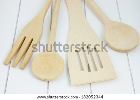 wooden kitchen utensils such as spoon, knife,  and spatula
