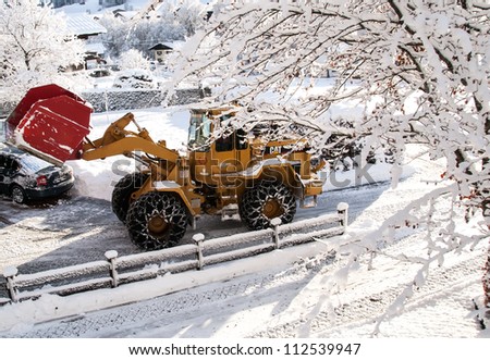 INNSBRUCK; AUSTRIA - JAN 08: Snow removal vehicle removing snow after blizzard which caused several damages on the streets of Innsbruck in Tirol, Austria on January 08, 2012.