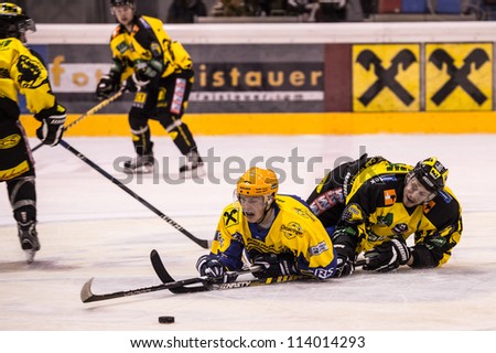 ZELL AM SEE, AUSTRIA - SEPT 22: Hockey game between EK Zell am See and EHC Lustenau. Hard battle for the puck, in Eisbaeren Arena, Zell am See, Austria on September 22, 2012