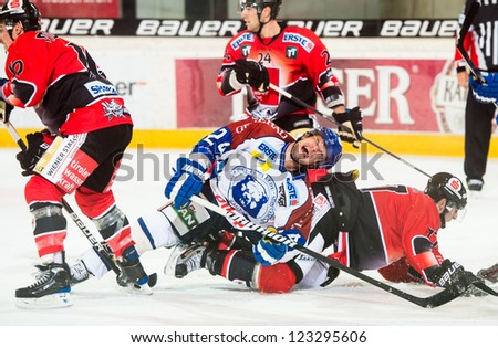 INNSBRUCK, AUSTRIA - AUG 25: Hockey game between HC Innsbruck and Medvescak Zagreb. Curtis Fraser of Zagreb goes down in pain after hard hit, in Olympia Hall, Innsbruck, Austria on August 25, 2012.