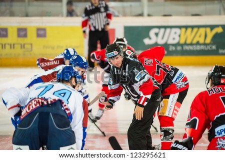 INNSBRUCK, AUSTRIA - AUG 25: Hockey game between HC Innsbruck and Medvescak Zagreb. Referee drops the puck for the opening face off, in Olympia Hall, Innsbruck, Austria on August 25, 2012.