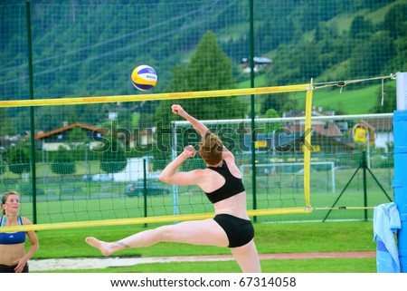 ZELL AM SEE, AUSTRIA - JUNE 26: Manuela Herbst smashing ball in a preliminary game at Beach City 2010 the biggest amateur Beach Volleyball Tournament in Austria. June 26, 2010 in Zell am See, Austria