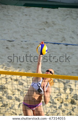 ZELL AM SEE, AUSTRIA - JUNE 26: Judith Zahn smashing the ball in a preliminary game at Beach City 2010 the biggest amateur Beach Volleyball Tournament in Austria. June 26, 2010 in Zell am See, Austria