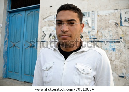 Angry tunisian man during violent protests on the street of Tunis.