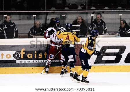 ZELL AM SEE, AUSTRIA - FEB 1: Austrian National League. Wurzer and Ron Pasco battle. Game EK Zell am See vs. ATSE Graz (Result 4-1) on February 1, 2011, at hockey rink of Zell am See