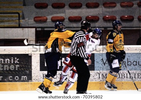 ZELL AM SEE, AUSTRIA - FEB 1: Austrian National League. Referee watching hard hit. Game EK Zell am See vs. ATSE Graz (Result 4-1) on February 1, 2011, at hockey rink of Zell am See