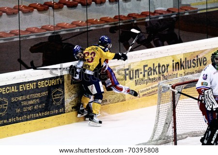 ZELL AM SEE, AUSTRIA - FEB 1: Austrian National League. Phillipp Ullrich hits Graz player. Game EK Zell am See vs. ATSE Graz (Result 4-1) on February 1, 2011, at hockey rink of Zell am See