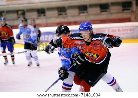 ZELL AM SEE, AUSTRIA - FEB 13: Salzburg hockey League. Stefan Leitgob tripped by Morzg player. Game SV Schuttdorf vs HCS Morzg  (Result 9-3) on February 13, 2011 at the hockey rink of Zell am See