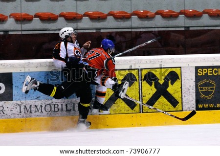 ZELL AM SEE, AUSTRIA - MARCH 19: Salzburg hockey League. Hard hit by Meixner leading to major penalty. SV Schuettdorf vs Salzburg Sud (Result 10-4) on March 19, 2011 at the hockey rink of Zell am See.