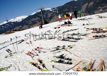 KAPRUN AUSTRIA - MARCH 5: Maiskogel Fanlauf 2011. Many pairs of ski at the target area of charity ski race with many celebrities in austria on March 5, 2011 at the Maiskogel in Kaprun, Austria