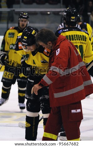 ZELL AM SEE; AUSTRIA - SEPT 24: Austrian National League. A ambulance man helps a hurt player of Lustenau. Game EK Zell am See vs EHC Lustenau (Result 1-8) on September 24, 2011 in Zell am See.