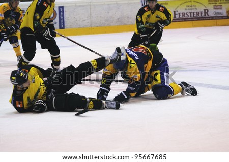 ZELL AM SEE; AUSTRIA - SEPT 24: Austrian National League. A player of EHC (yellow jersey) falls over a player of EKZ. EK Zell am See vs EHC Lustenau (Result 1-8) on September 24, 2011 in Zell am See.