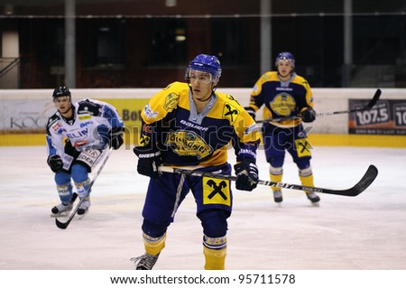 ZELL AM SEE; AUSTRIA - OCT 01: Austrian National League. A player of EKZ (blue jersey) is focused on the puck. Game EK Zell am See vs Linz II (Result 5-2) on October 01, 2011 in Zell am See.